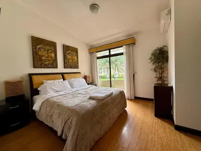 a bedroom with a large bed and a window at CR MARIPOSA RENTALS lakeview, spacious penthouse with office, pool, gym, Jacuzzi in Santa Ana
