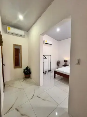 a white room with a bed and a room with a bed sqor at EBK Surf Apartamento 1 in Santa Cruz