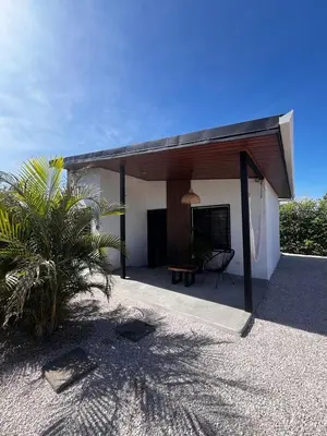 a white house with a roof with a patio at EBK Surf Apartamento 1 in Santa Cruz