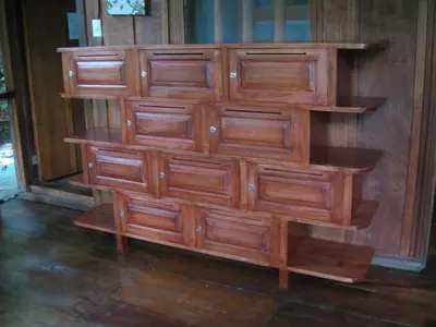 a wooden cabinet with four shelves on a wall at Luz En El Cielo Eco-B&B/Hostel in Montezuma