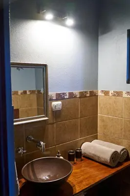a bathroom with a sink and a mirror at Luz En El Cielo Eco-B&B/Hostel in Montezuma