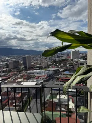 a view of a city from the balcony of a building at Modern Stay in Trendy Escalante 1803 in Tapantí