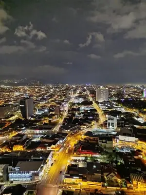 a view of a city at night with lights at Modern Stay in Trendy Escalante 1803 in Tapantí
