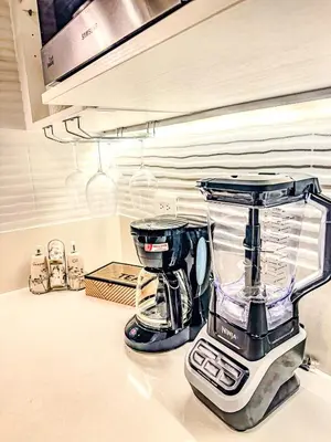a blender sitting on top of a kitchen counter at Modern Stay in Trendy Escalante 1803 in Tapantí