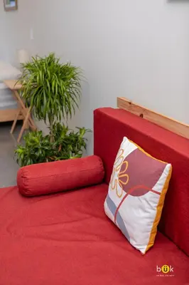 a red couch with a pillow on top of it at URBN Cozy Studio Sunset 806a in Tapantí