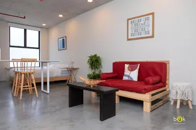 a living room with a red couch and a table at URBN Cozy Studio Sunset 806a in Tapantí