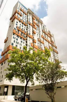 a tall building with a tree in front of it at URBN Cozy Studio Sunset 806a in Tapantí