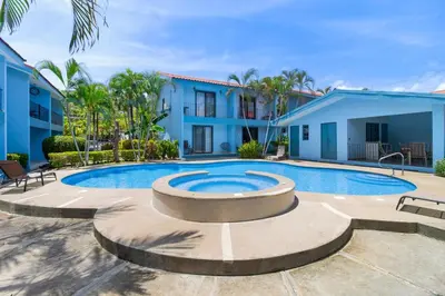 a swimming pool in the courtyard of a villa at Coco - Laguna Azul Poolside Condo in Coco