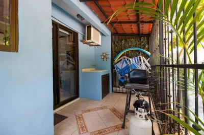 a room with a porch with a sink at Coco - Laguna Azul Poolside Condo in Coco