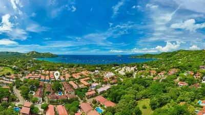 an aerial view of a city and the ocean at Coco - Laguna Azul Poolside Condo in Coco