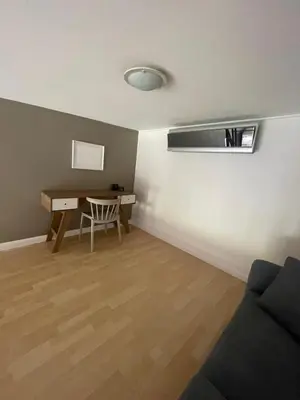 a living room with a desk and a table at CR MARIPOSA RENTALS Brand New lake view Penthouse with office space in Santa Ana