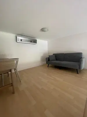 a living room with a couch and a table at CR MARIPOSA RENTALS Brand New lake view Penthouse with office space in Santa Ana