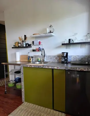 a kitchen with a sink and a counter at Sea song cabin with private waterfall and river in Monteverde Costa Rica