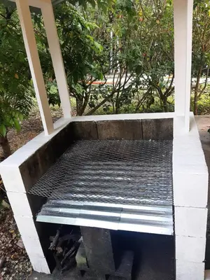 a concrete bench sitting on top of a porch at Casa Esmeralda in Paquera