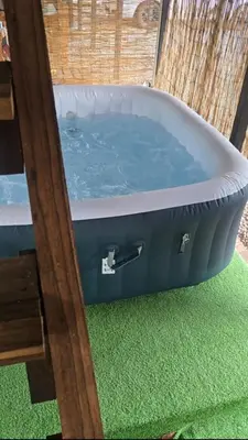a bath tub sitting on top of a green rug at CocoRelax in Siquirres