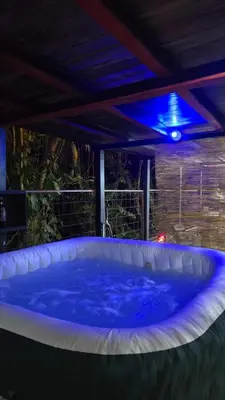 a hot tub in a backyard with a blue light at CocoRelax in Siquirres