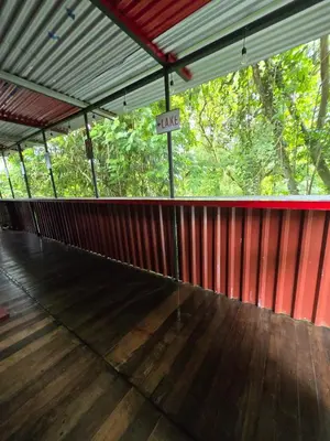 a large red building with a risk sign on the floor at CocoRelax in Siquirres