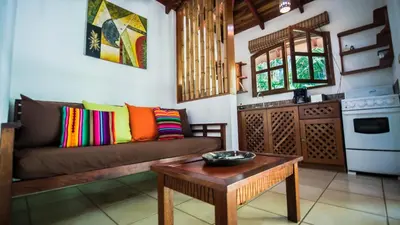 a living room with a couch and a coffee table at Hotel El Pequeño Gecko Verde in Sámara