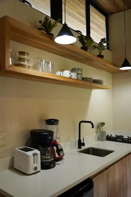 a kitchen counter with a toaster and a sink at VED Beach Deluxe Studio 2, Steps to the Beach in Santa Teresa Beach