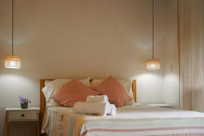 a bedroom with a bed with two towels on it at VED Beach Deluxe Studio 2, Steps to the Beach in Santa Teresa Beach