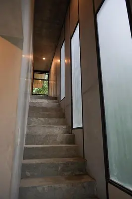 a staircase leading up to a building with windows at VED Beach Deluxe Studio 3, Steps to the Beach in Santa Teresa Beach