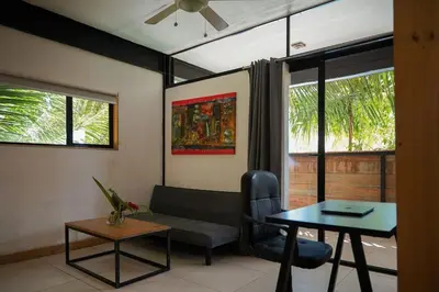 a living room with a couch and a table at VED Beach Apt 4 - Steps to the Beach in Santa Teresa Beach