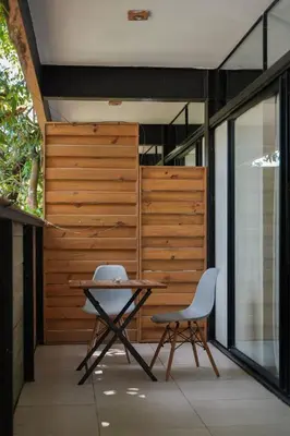 a table and two chairs sitting on a patio at VED Beach Apt 4 - Steps to the Beach in Santa Teresa Beach