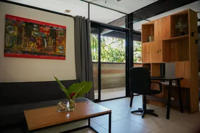 a room with a desk and a chair and a window at VED Beach Apt 4 - Steps to the Beach in Santa Teresa Beach