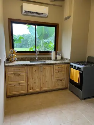 a kitchen with a sink and a window at Luciernaga in Bahia