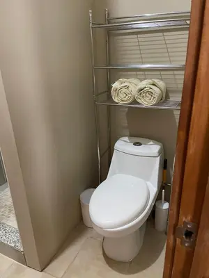 a bathroom with a white toilet and towels at Luciernaga in Bahia
