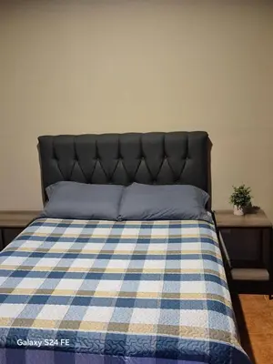 a bedroom with a bed with a blue and white checkered blanket at Guacamaya in Bahia