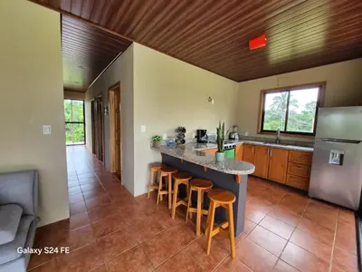 a kitchen with a large island with bar stools at Guacamaya in Bahia
