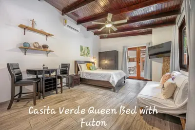 a bedroom with a bed and a desk and a bed at Main Villa plus 2 casitas, 5 BR, POOL, canaba w grill in Tamarindo