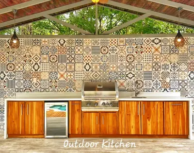 a kitchen with a stove and a tile wall at Main Villa plus 2 casitas, 5 BR, POOL, canaba w grill in Tamarindo