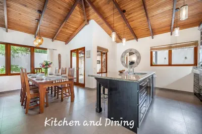 a kitchen and dining room with a wooden ceiling at Main Villa plus 2 casitas, 5 BR, POOL, canaba w grill in Tamarindo