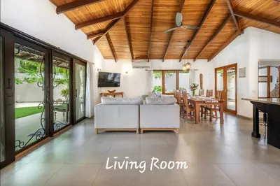 a living room with a couch and a table at Main Villa plus 2 casitas, 5 BR, POOL, canaba w grill in Tamarindo