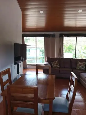 a living room with a couch and a table at Linda vista in Bijagua