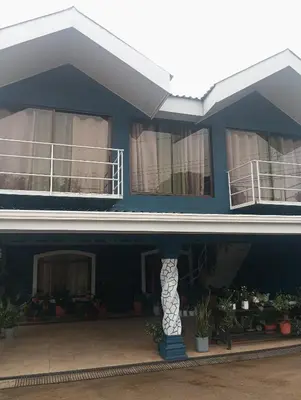 a blue house with two balconies on top of it at Linda vista in Bijagua