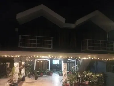 a stage with lights and potted plants at night at Linda vista in Bijagua