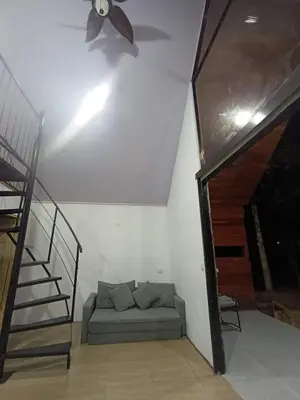 a living room with a couch and a ceiling fan at Kono Rainbow Finca paraíso in Jiménez