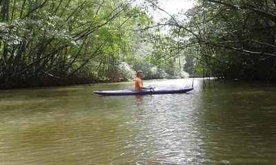 a man is sitting in a kayak in the water at El Castillo Divertido in Paraíso