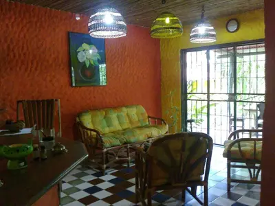 a living room with a couch and chairs and a table at El Castillo Divertido in Paraíso