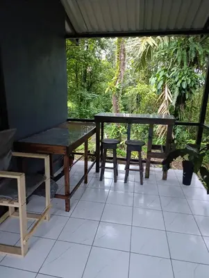 a table and chairs sitting on a tiled floor at Chava Lodge On Tenorio Rio Celeste in Rio Celeste