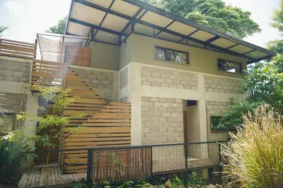 a house with wooden stairs in front of it at VED Beach Apt 5 - Steps to the Beach in Santa Teresa Beach