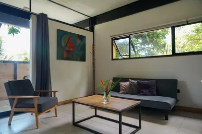 a living room with a couch and a table at VED Beach Apt 5 - Steps to the Beach in Santa Teresa Beach