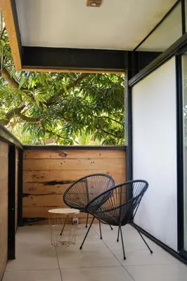 a patio with a chair and a table at VED Beach Apt 5 - Steps to the Beach in Santa Teresa Beach