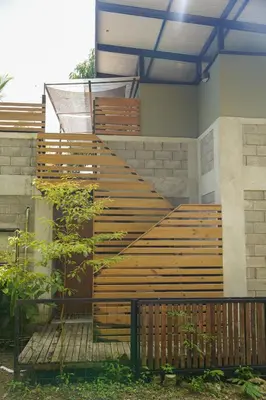 a set of wooden stairs on the side of a building at VED Beach Terrace Apt 6 - Steps to the Beach in Santa Teresa Beach