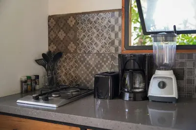 a kitchen counter with a blender on a counter top at VED Beach Terrace Apt 6 - Steps to the Beach in Santa Teresa Beach