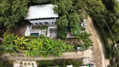 an aerial view of a house in the forest at VED Beach Apt 1 - 1BDR, Pool, Steps to the Beach in Santa Teresa Beach
