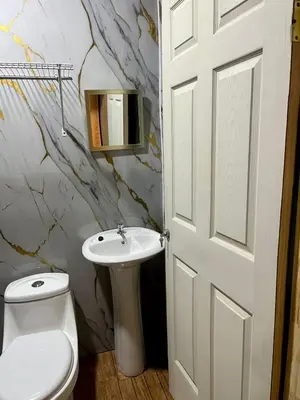 a bathroom with a white toilet and a sink at Luisito steak House & Hotel in Fortuna